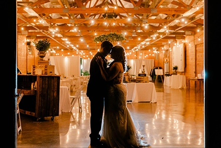 A couple in a brightly decorated barn